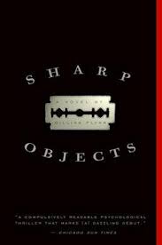Cover of Sharp Objects. A metal plaque against a black background.